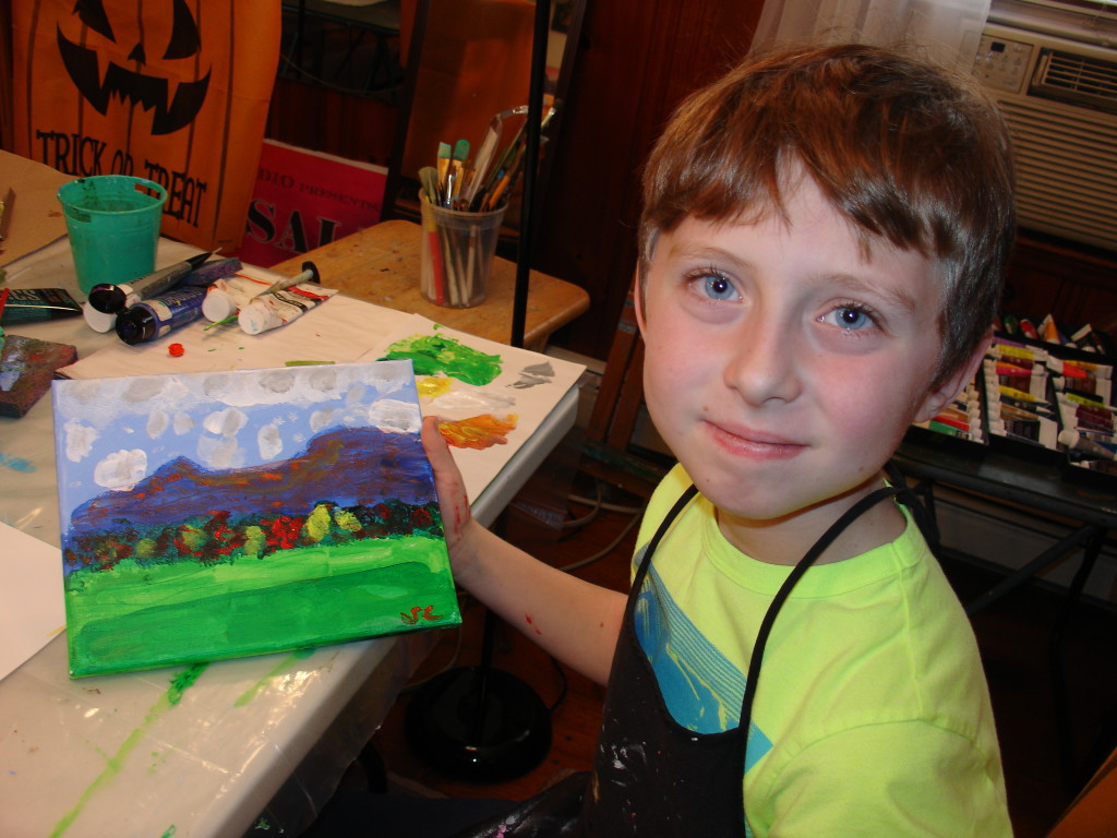 New student Steven Cooper displays his acrylic of the Blue Mountain Range